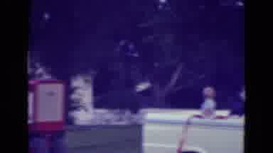 Diller Nebraska (1965): Man In Red Wagon Rolling Towards A White Pickup Truck With