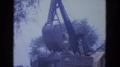 Louisville Kentucky USA (1965): A Crane Pouring Dirt Into A Dumpster And A House