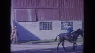 Louisville Kentucky USA (1965): Two People Riding Their Horses Around Outside A