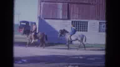 Louisville Kentucky USA (1965): Two Children On Horses Lead Them Away From The