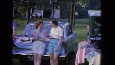 Manchester New Hampshire (1965): Man And Women Speak In Front Of Parked Cars On