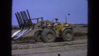Pueblo Mexico (1965): Man In A Yellow Digger Gets Ready To Plough The Field With