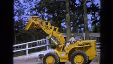 Pueblo Mexico (1965): Smaller Yellow Bulldozer Tractor Operated By A Man Who Is