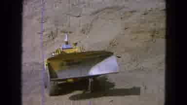 Pueblo Mexico (1965): An Employee Operating A Front Loader To Scoop Dirt At A