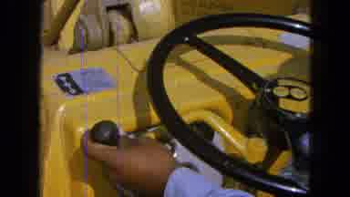 Pueblo Mexico (1965): Footage Of A Man Changing Gear In A Yellow Piece Of Farm