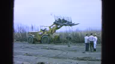 Pueblo Mexico (1965): Men Observe Yellow Construction Vehicle Pushing Large