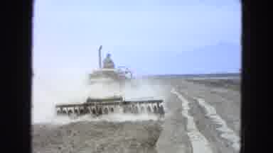 Pueblo Mexico (1965): A Guy Driving Ba Machine Across The Filled Trying To Lay The