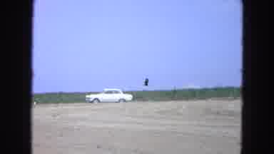 Pueblo Mexico (1965): A Car And A Construction Machinery Parked Near A Land That