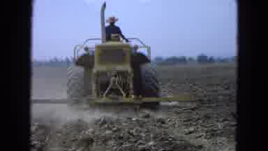 Pueblo Mexico (1965): Farmer In Hat Driving Tractor Through Barren Farmland While