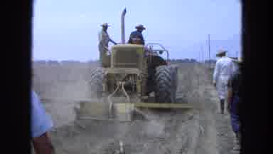 Pueblo Mexico (1965): A Scene Of A Man On Tractor With People Walking
