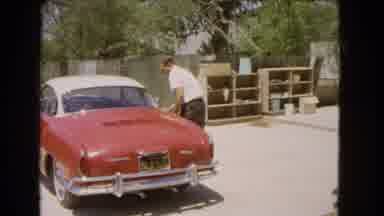 Barstow California USA (1966): Man Closing Vintage Car And Walking Away With His