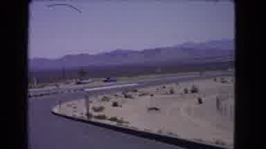 California USA (1966): Car Drives Slowly While Filming On A Curved Highway In