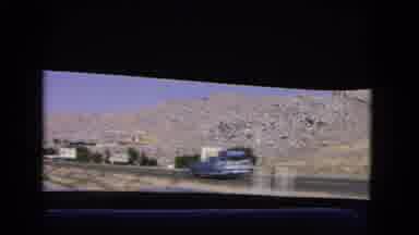 California USA (1966): Cars On The Road Were There Are Signs And Trees Outside