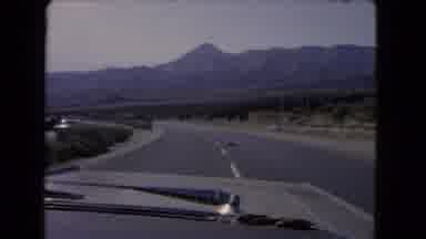 California USA (1966): Vintage Old Time Car Rides Through The Hillside In The