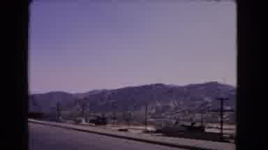California USA (1966): Hillside Terrain Is Shown And Some Cars Are Passing Through
