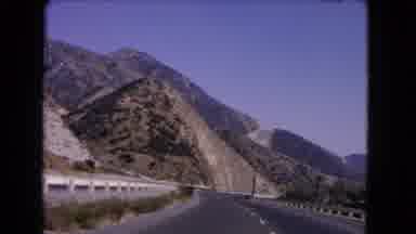 California USA (1966): Driving Down A Mountainous Highway During The Day Showing