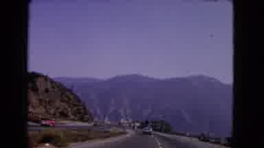 California USA (1966): Riding In A Car Along A Mountainous Four Lane Road Going
