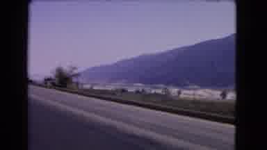 California USA (1966): Highway Footage Of Town In The Distance Filmed From A