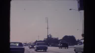 California USA (1966): Vehicles Are Passing In The Crowded Highway Across Centre