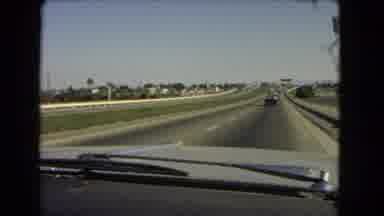 California USA (1966): Car Is Driving Down The Highway And The Grass Is Also Shown