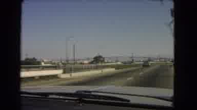 California USA (1966): A Car Driving Along The Highway Near A Bridge