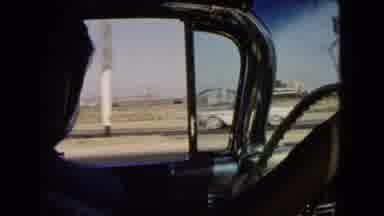 California USA (1966): Man Driving Talks To The Camera As Camera Captures The