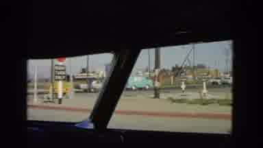 California USA (1966): The Car Is Sitting On The Road And Travels In That Town