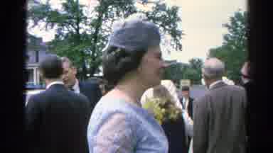 DANVILLE ILLINOIS-1966: Well Dressed People Converse Outside Surrounded By Trees