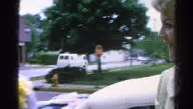 Danville Illinois (1966): Woman With A Pearl Necklace Waves To The Camera Outside