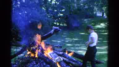 Danville Illinois (1966): Little Boy Tosses Something On The Bonfire And Mother