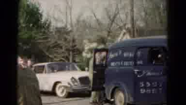 Hagerstown Maryland USA (1966): A Big Blue Stopped Car And People Moving Itself In