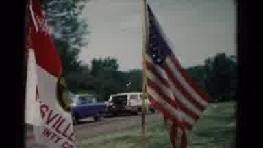 Hagerstown Maryland USA (1966): United States Flag Blowing In The Wind With Cars