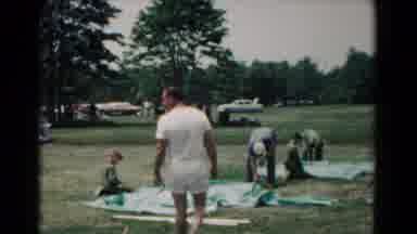 Hagerstown Maryland USA (1966): Man Walking In A Park While Other People Built A