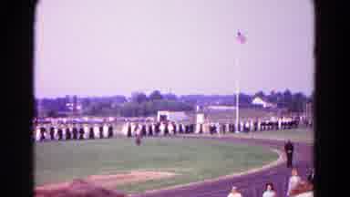 Hagerstown Maryland USA (1966): Group Of People Walking On A Field As People Watch