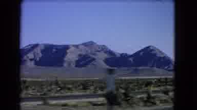 Las Vegas Nevada (1966): Driving On A Freeway Passing Mountains And Road Signs And