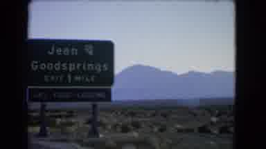 Las Vegas Nevada (1966): Driving Down Road In Rural Landscape Past Texaco Sign And