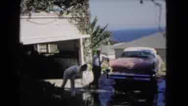 Los Angeles California (1966): Man Washes His Garage On A Sunny And Hot Day