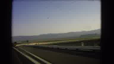 Nevada USA (1966): Car Ride In The Sunset Of An Empty Road With Mountains Around