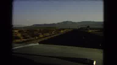 Nevada USA (1966): Driving Down Lonely Highway Near An Exit Ramp In The Desert