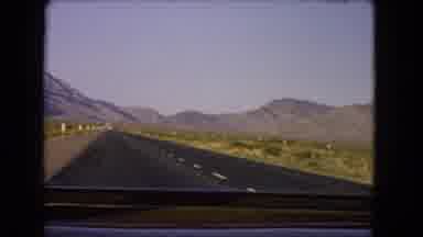 Nevada USA (1966): Traveling Highway In Desert With Mountains In Background