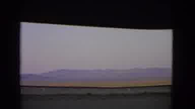 Nevada USA (1966): Car Driving To The Right Looks Off Into Distant Mountains As
