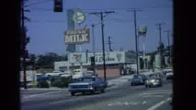 San Pedro California USA (1966): Busy Street With Cars Passing By A Fried Chicken