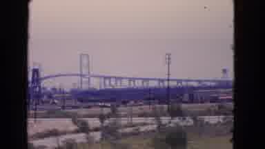 San Pedro California USA (1966): Driving Through A Town With The View Of A Bridge