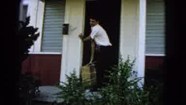 San Pedro California USA (1966): A Young Man And Woman Carrying Heavy Items From