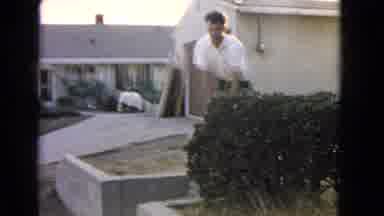 San Pedro California USA (1966): Guy Stumbling Carrying Stack