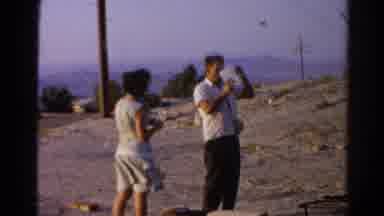 Silver Lake California (1966): Man Drinks From Jug On A Building Site While Woman
