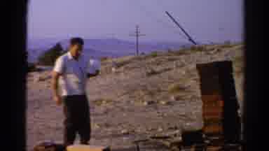 Silver Lake California (1966): A Man Standing Next To Lots Of Wood And Placing A
