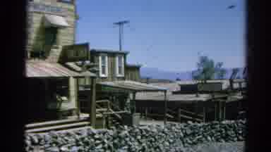 Silver Lake California (1966): View Of Brown Wooden Buildings Mountain And Lake On