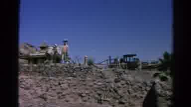 Silver Lake California (1966): Man Standing In The Desert With Some Buildings