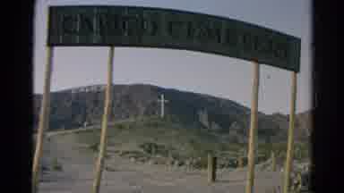 Silver Lake California (1966): View Of A Cross And Sign On Barren Mountain Top